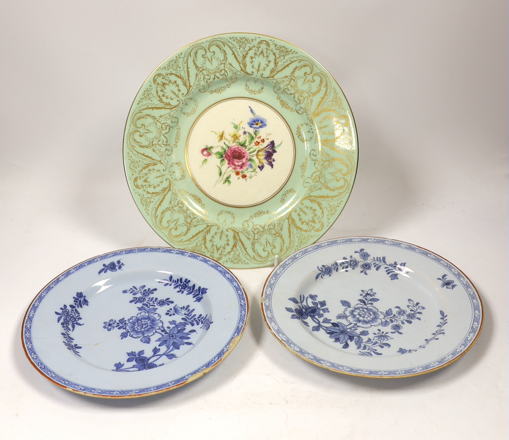 A pair of Delft plates, one dated 1771 and another Royal Worcester floral decorated plate, 27cm diameter